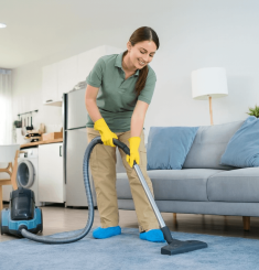 Essential Cleaning Essex County professional cleaner vacuuming living room carpet
